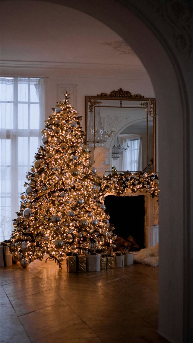 1290x2796 a decorated christmas tree in a living room - wood iPhone Wallpaper