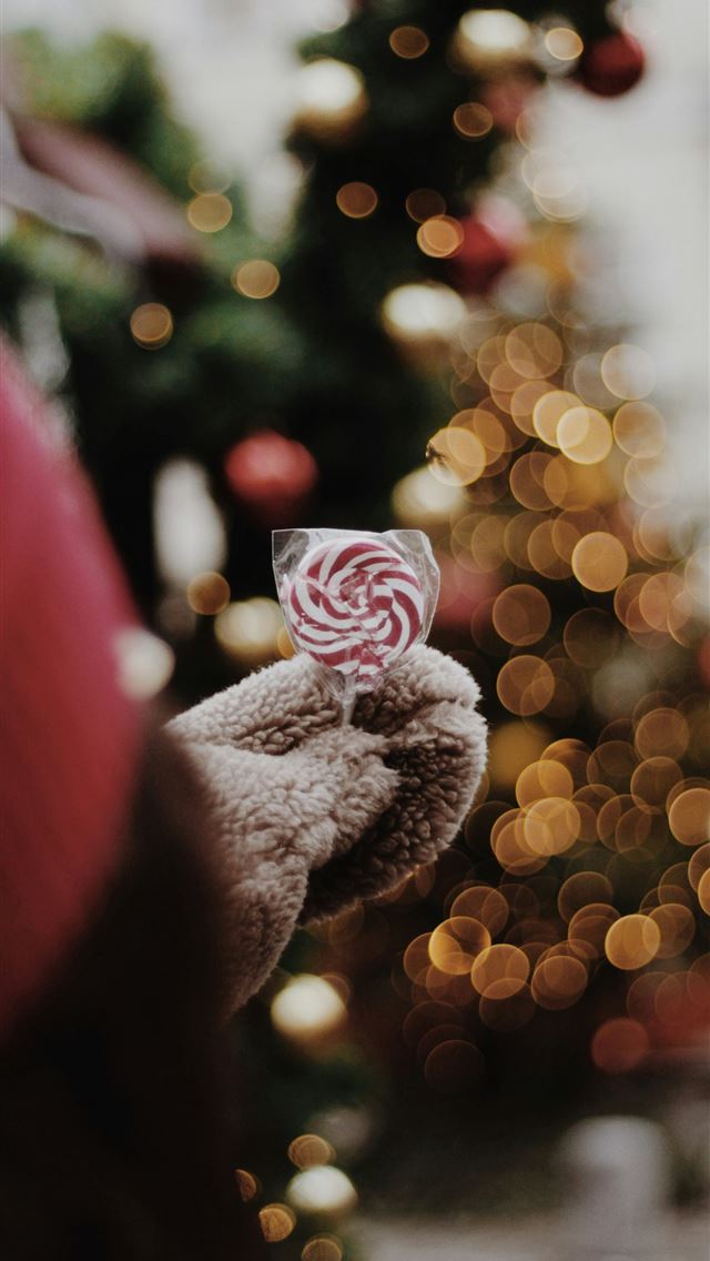 1290x2796 person holding candy selective focus photography - christmas iPhone Wallpaper