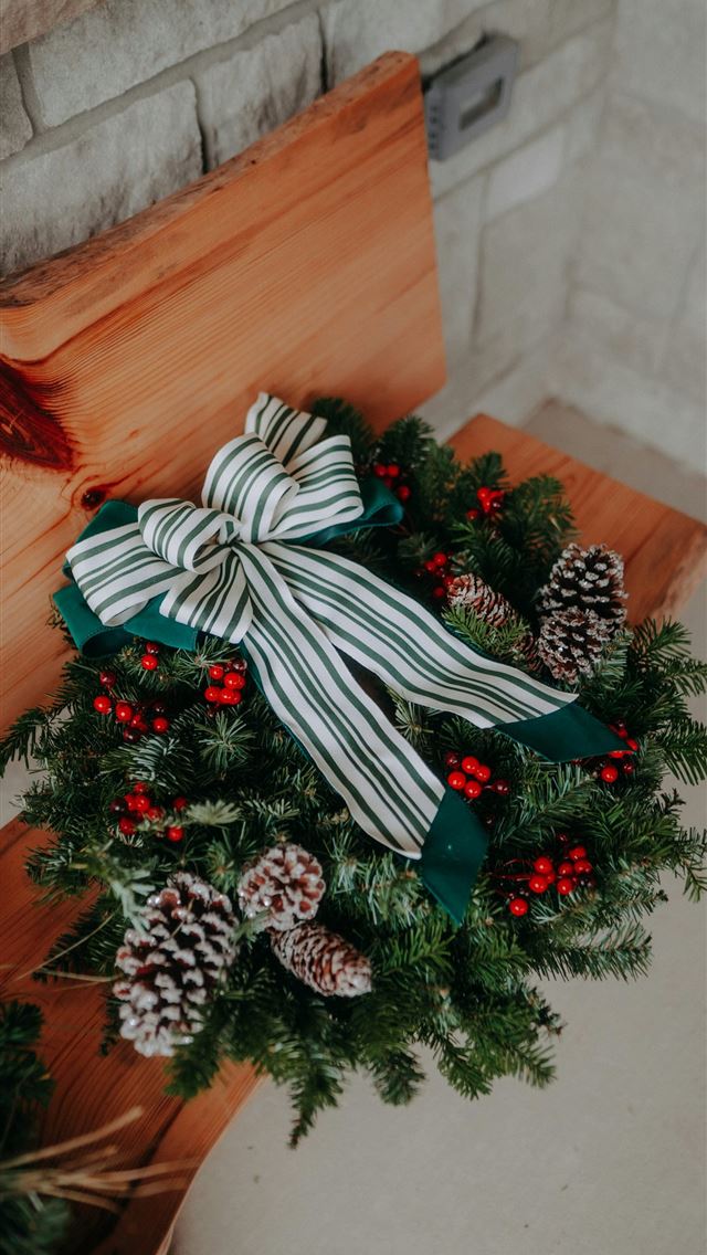 1290x2796 A christmas wreath on top of a wooden bench -  iPhone Wallpaper