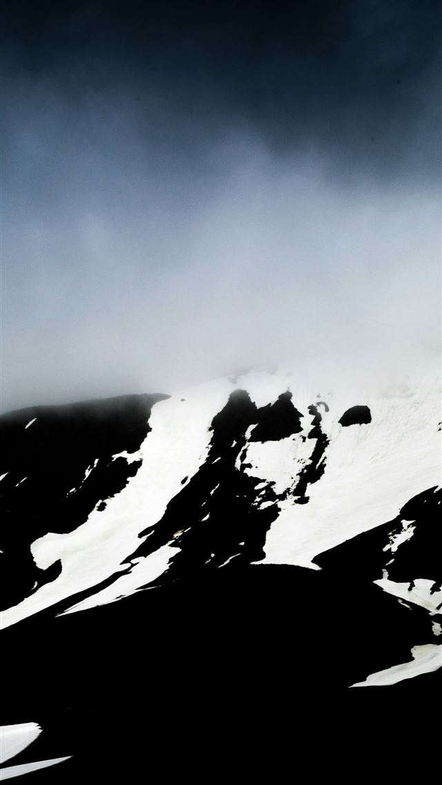 1290x2796 a mountain covered in snow under a cloudy sky -  iPhone Wallpaper