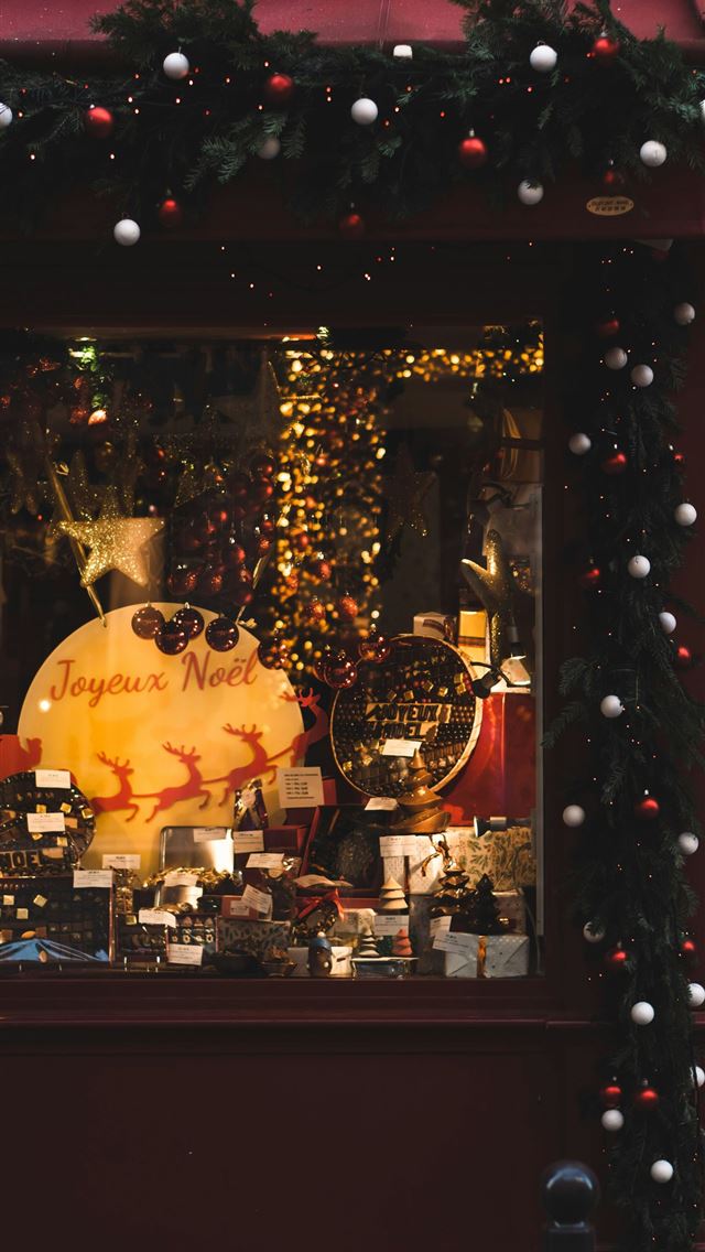 1290x2796 a store front with a christmas display in the wind... - christmas iPhone Wallpaper