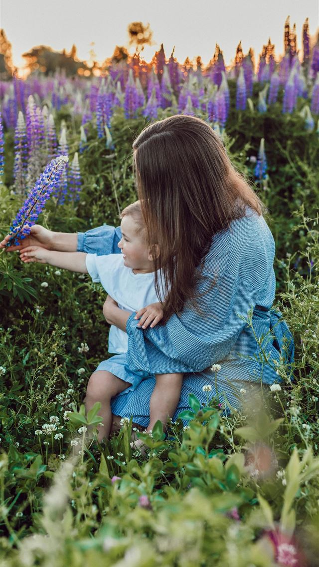 1290x2796 woman sitting with baby on her lap surrounded with... -  iPhone Wallpaper