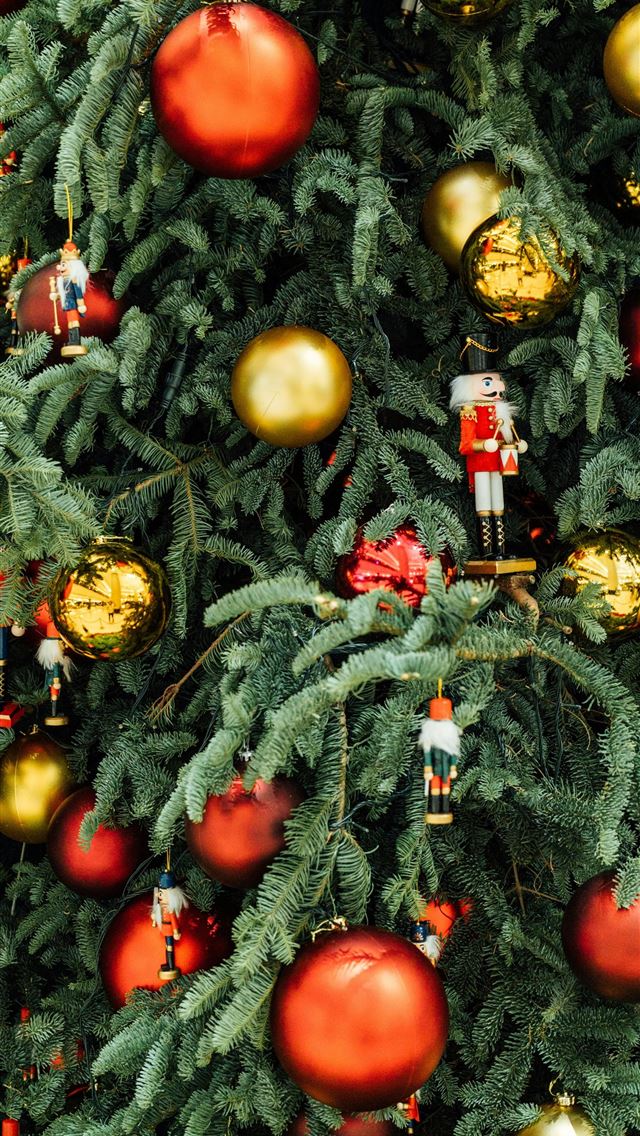 1290x2796 a christmas tree with ornaments hanging from it -  iPhone Wallpaper