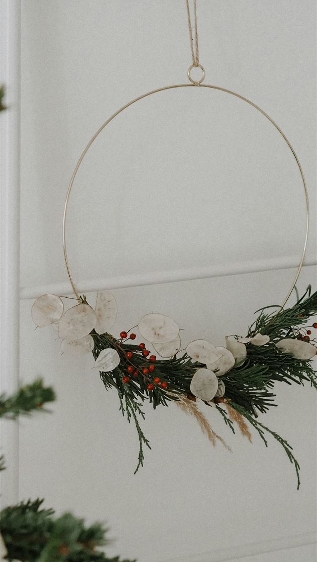 1290x2796 a christmas wreath hanging on a wall -  iPhone Wallpaper