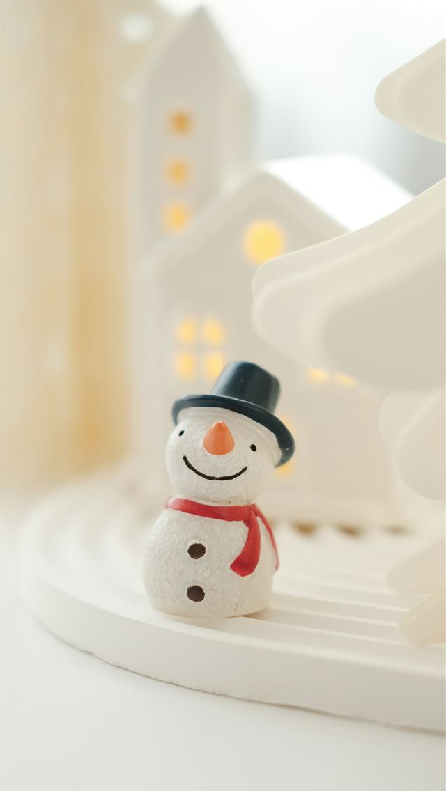 1290x2796 A snowman figurine sitting in front of a christmas... -  iPhone Wallpaper
