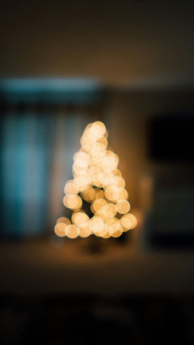 1290x2796 a blurry photo of a lit christmas tree -  iPhone Wallpaper