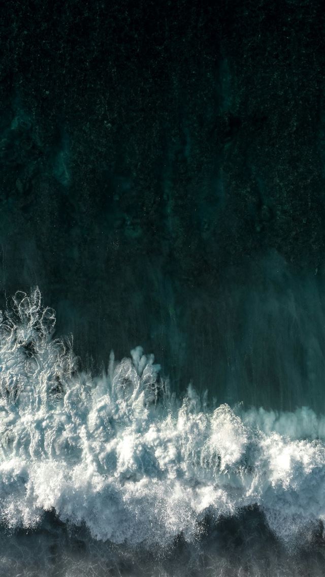 1290x2796 A surfer riding a wave in the ocean -  iPhone Wallpaper