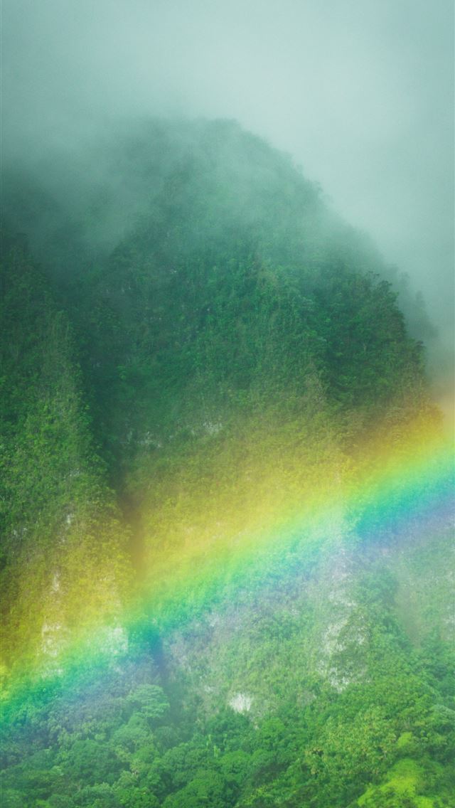 1290x2796 A rainbow arcs over the lush green mountains  -  iPhone Wallpaper