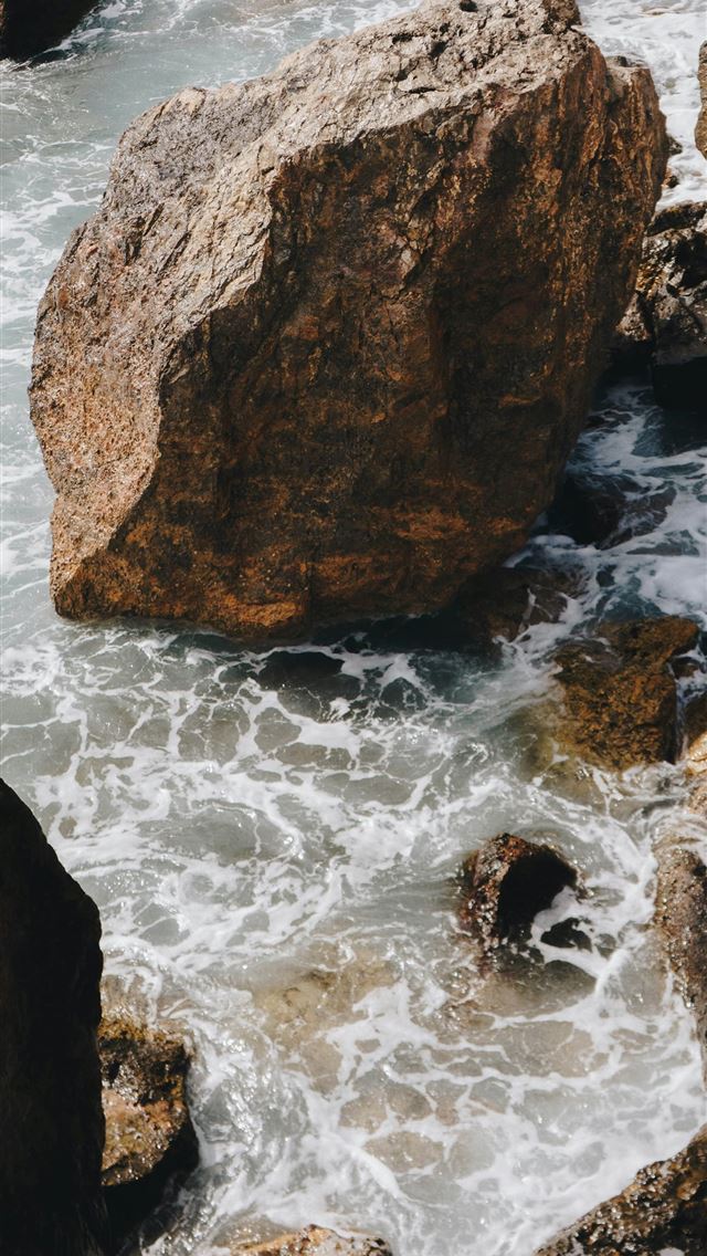 1290x2796 Waves crash around large rocks at the shore  -  iPhone Wallpaper