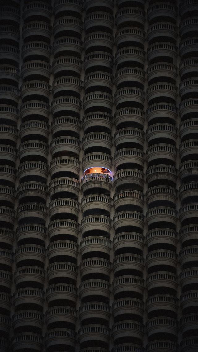 1290x2796 A single lit balcony amidst many dark ones  -  iPhone Wallpaper