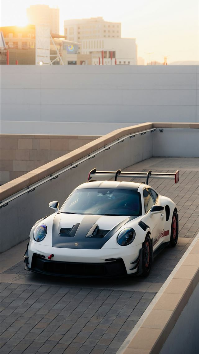 1290x2796 A white sports car on a ramp  -  iPhone Wallpaper