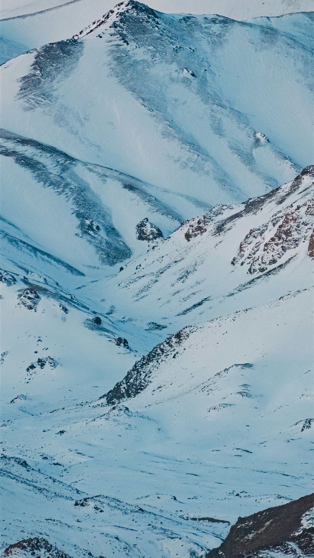 1290x2796 Snow covered mountains against a blue sky  -  iPhone Wallpaper