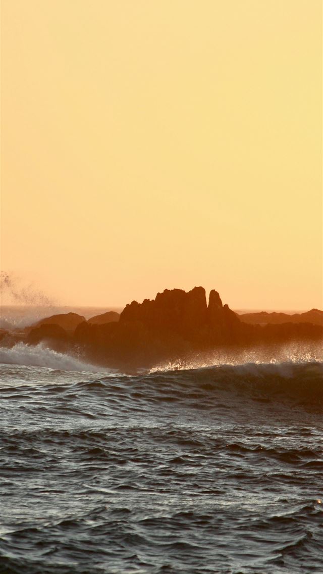 1290x2796 Waves crash against rocks at sunset  -  iPhone Wallpaper