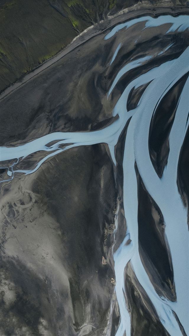 1290x2796 A river flows through a dark barren landscape  -  iPhone Wallpaper