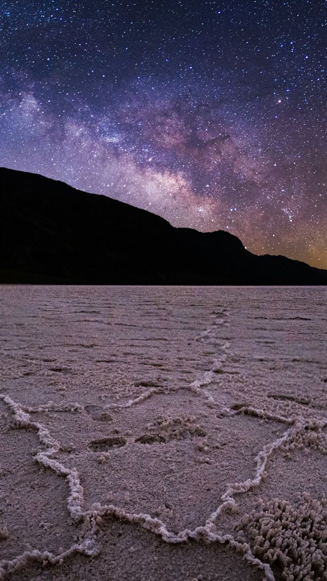 1290x2796 A view of the night sky over a desert -  iPhone Wallpaper