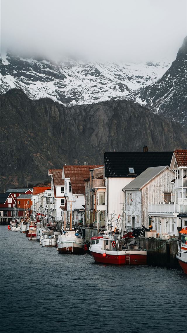 1290x2796 A group of boats that are sitting in the water -  iPhone Wallpaper