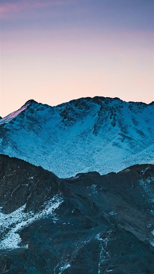 1290x2796 Snowy mountains silhouetted against a vibrant suns... -  iPhone Wallpaper