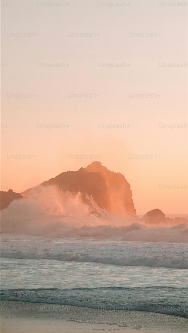 1290x2796 a large body of water sitting next to a sandy beac... -  iPhone Wallpaper