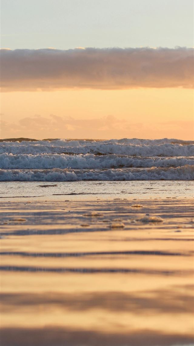 1290x2796 Sunrise illuminates the ocean waves and beach  -  iPhone Wallpaper