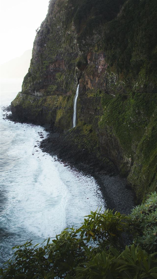 1290x2796 A waterfall on the side of a cliff next to the oce... -  iPhone Wallpaper