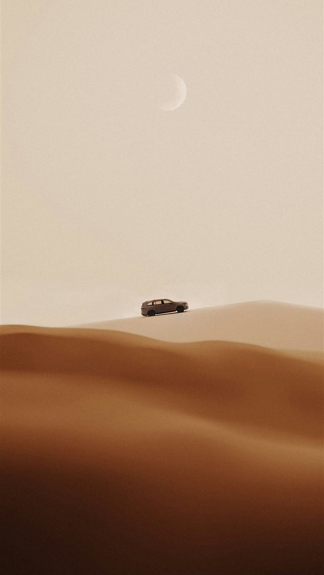 1290x2796 A car driving through the desert with a moon in th... -  iPhone Wallpaper