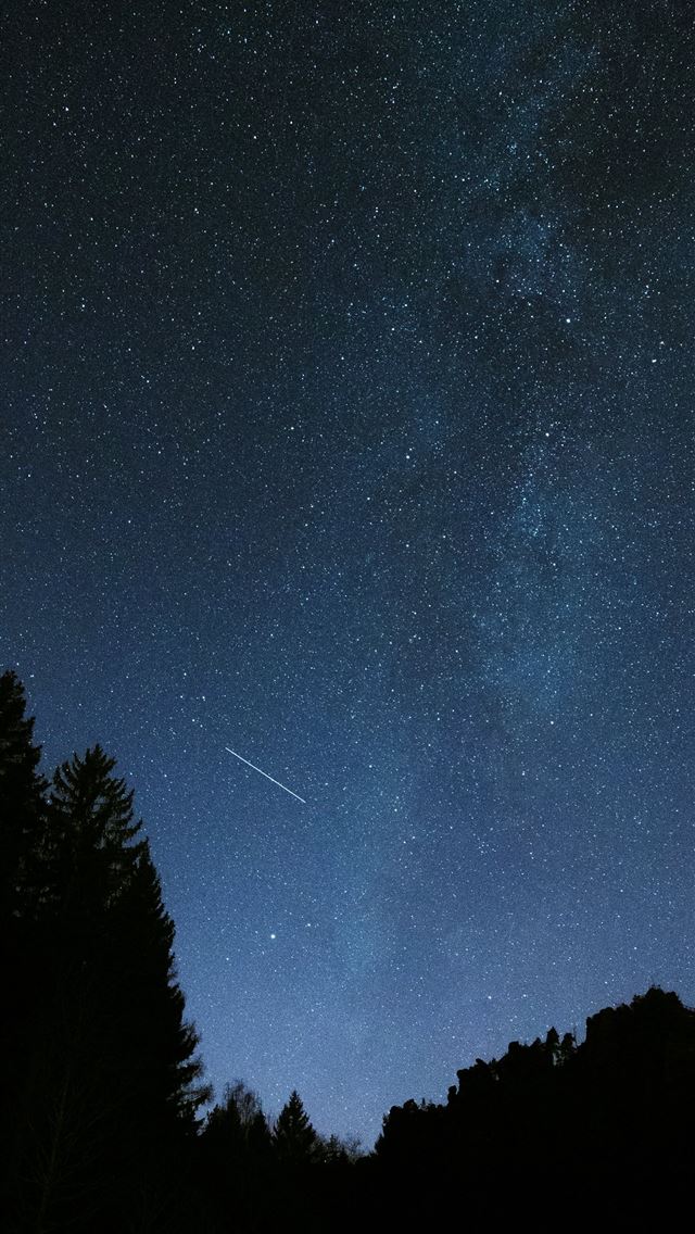 1290x2796 A night sky with a shooting star in the distance -  iPhone Wallpaper