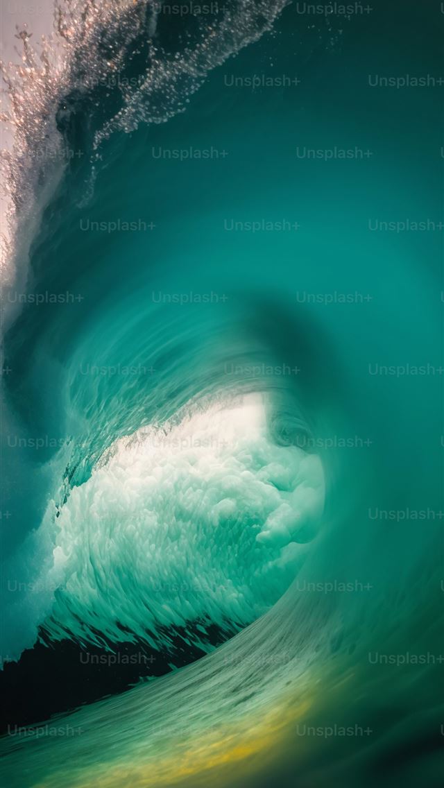 1290x2796 a large wave is breaking in the ocean -  iPhone Wallpaper