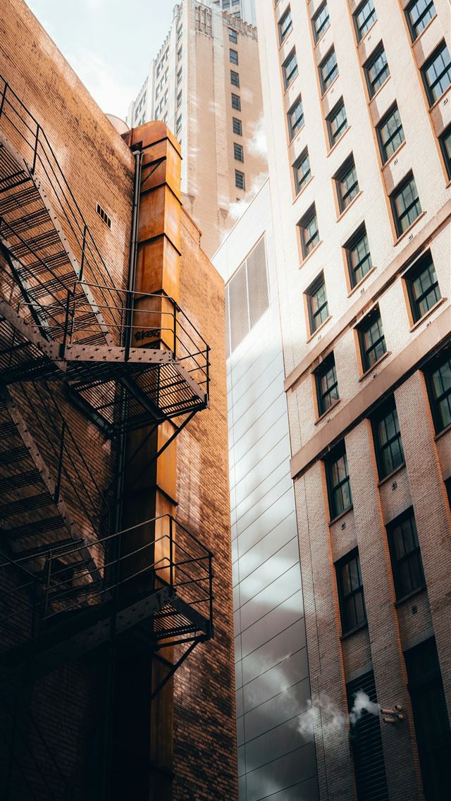 1290x2796 Buildings with a fire escape and beautiful sunligh... -  iPhone Wallpaper