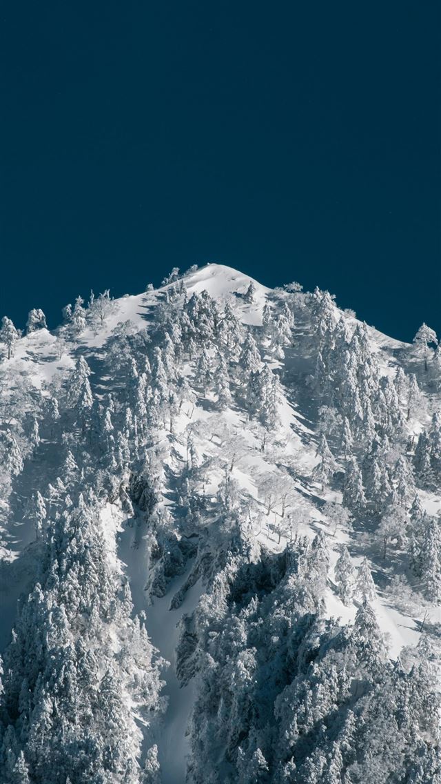 640x1136 A snow covered mountain with a ski lift in the bac... -  iPhone Wallpaper