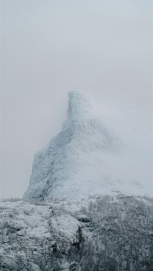 640x1136 A mountain covered in snow on a cloudy day -  iPhone Wallpaper
