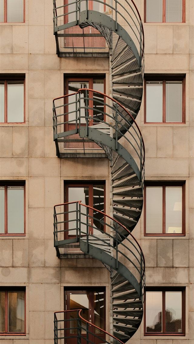 640x1136 A tall building with a spiral staircase in front o... -  iPhone Wallpaper