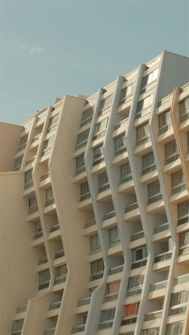 640x1136 Wavy building facade against a clear blue sky  -  iPhone Wallpaper