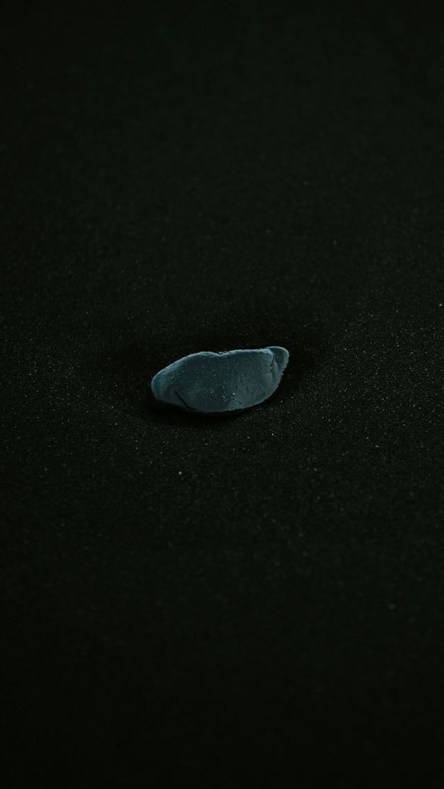 1290x2796 A black surface with a small piece of glass on it -  iPhone Wallpaper