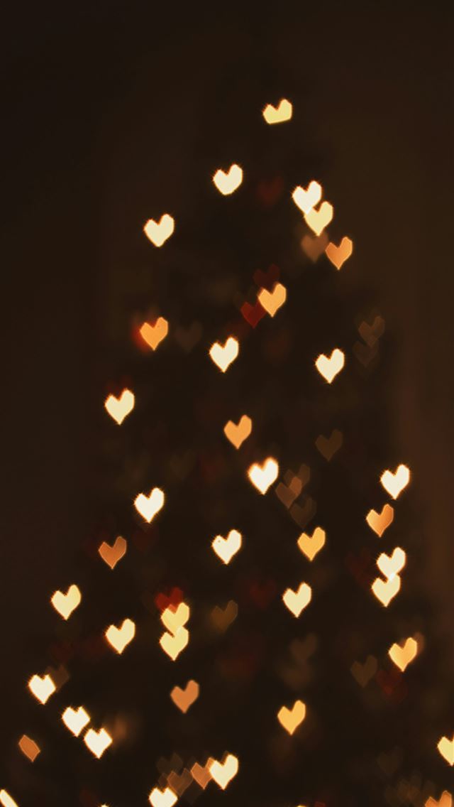1290x2796 A lit up christmas tree in a dark room -  iPhone Wallpaper
