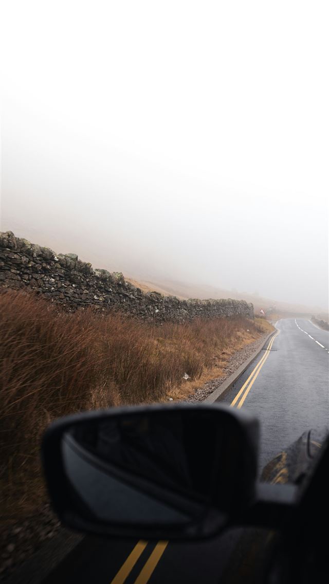 1290x2796 A car driving down a road in the fog -  iPhone Wallpaper