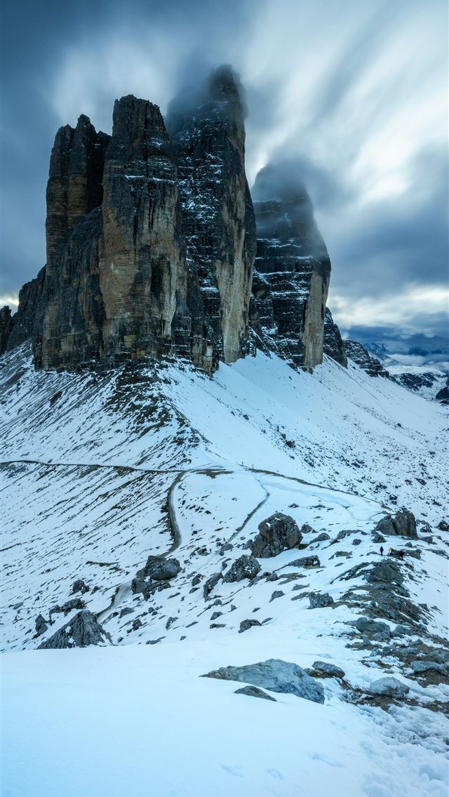 1290x2796 A snowy mountain with a large rock formation in th... -  iPhone Wallpaper