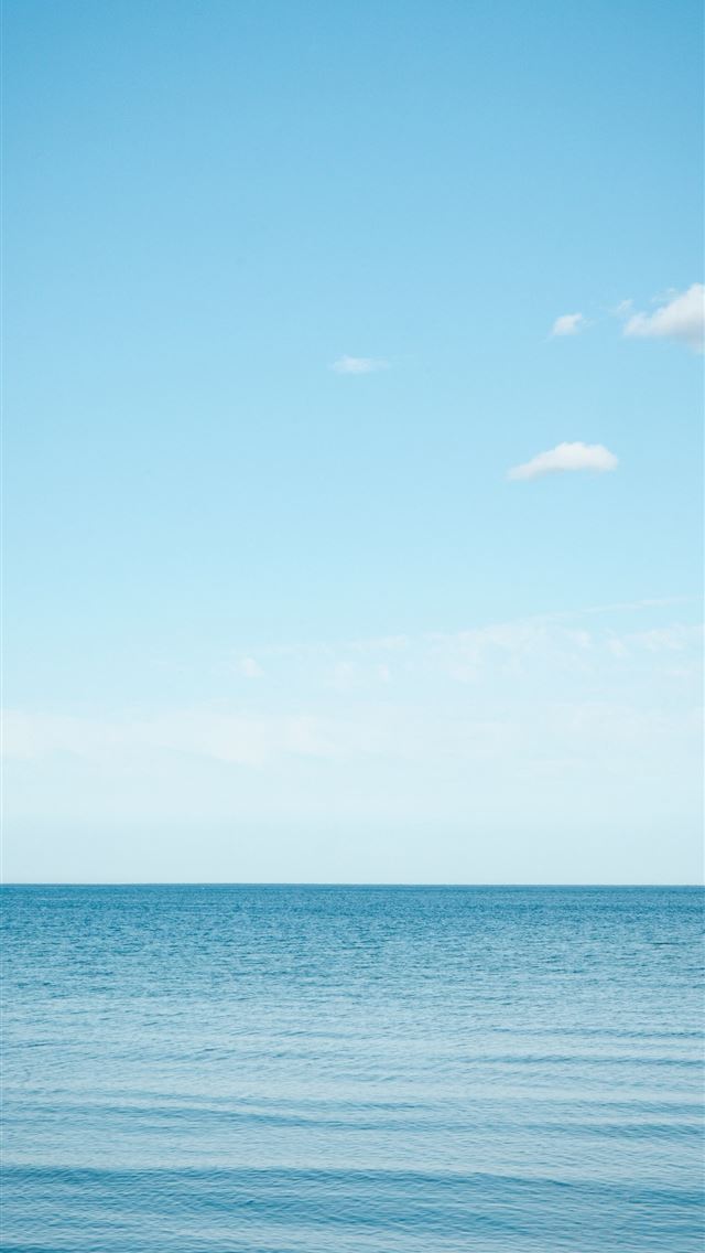 1290x2796 A large body of water sitting under a blue sky -  iPhone Wallpaper