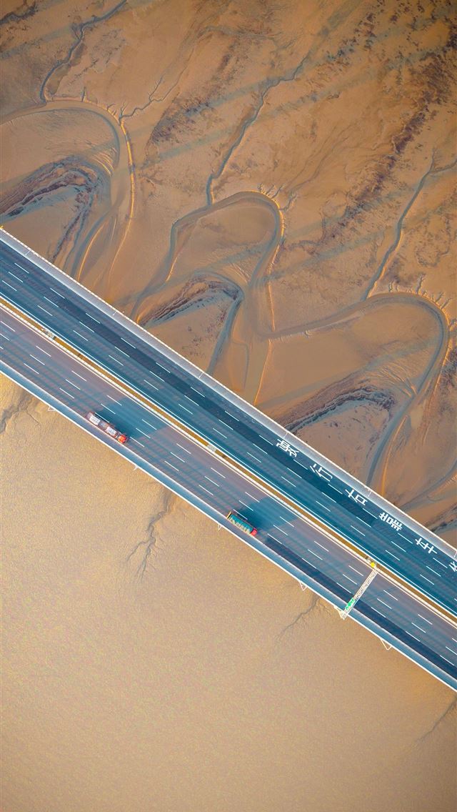 1290x2796 An aerial view of a bridge over mudflats  -  iPhone Wallpaper