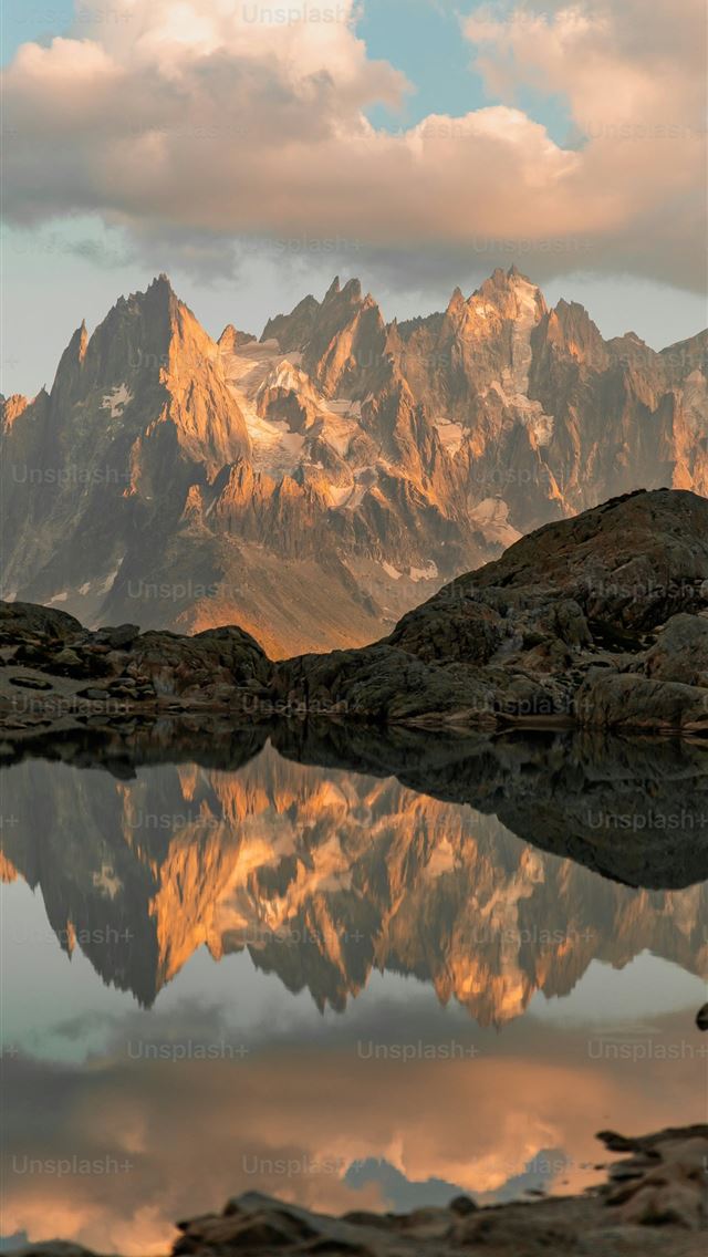 1290x2796 A mountain range is reflected in the still water o... -  iPhone Wallpaper