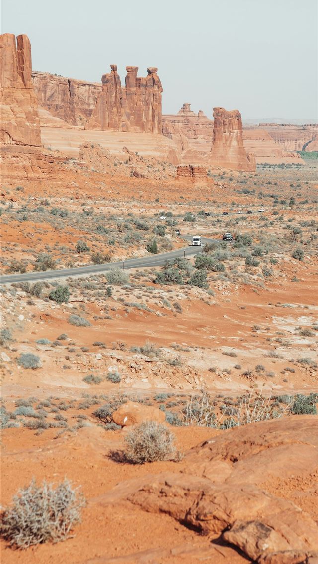 1290x2796 A dirt road in the middle of a desert -  iPhone Wallpaper