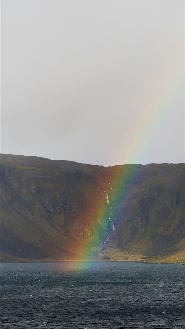 640x1136 A rainbow in the sky over a body of water -  iPhone Wallpaper