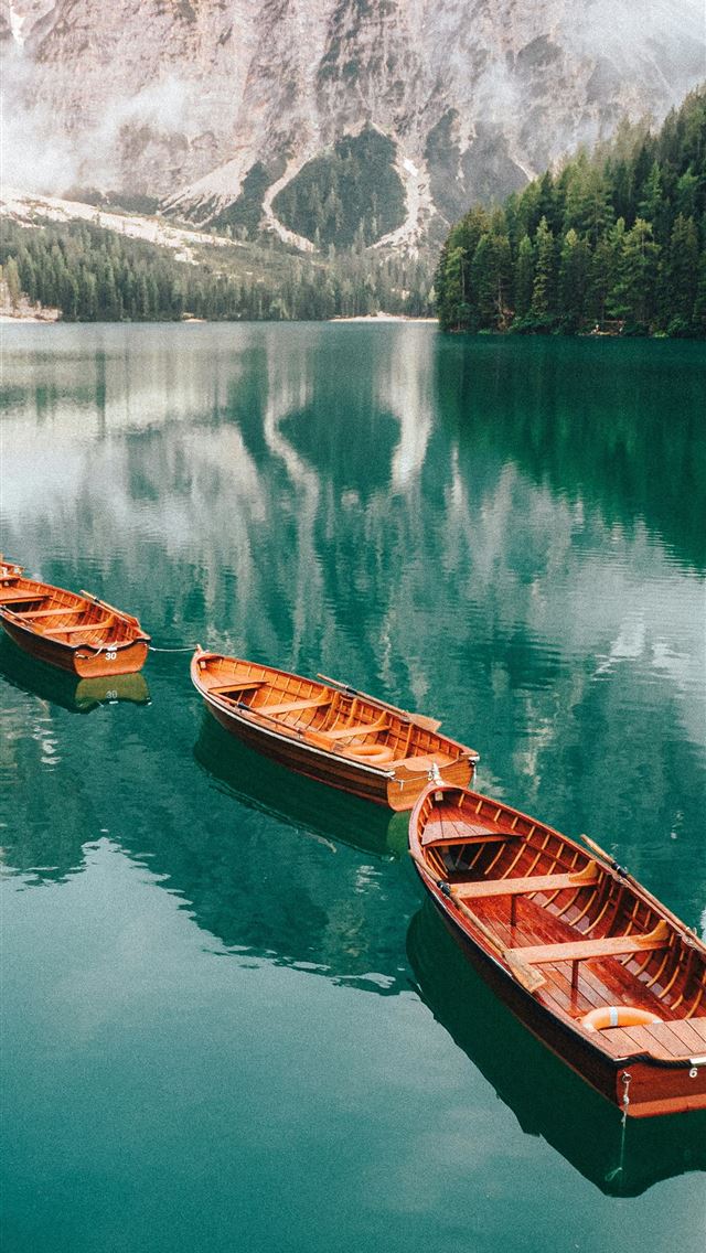 1290x2796 A group of boats floating on top of a lake -  iPhone Wallpaper