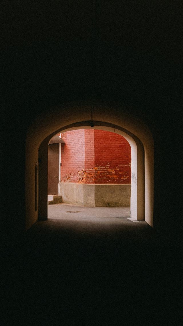1290x2796 Dark arched doorway leading to a red brick buildin... -  iPhone Wallpaper