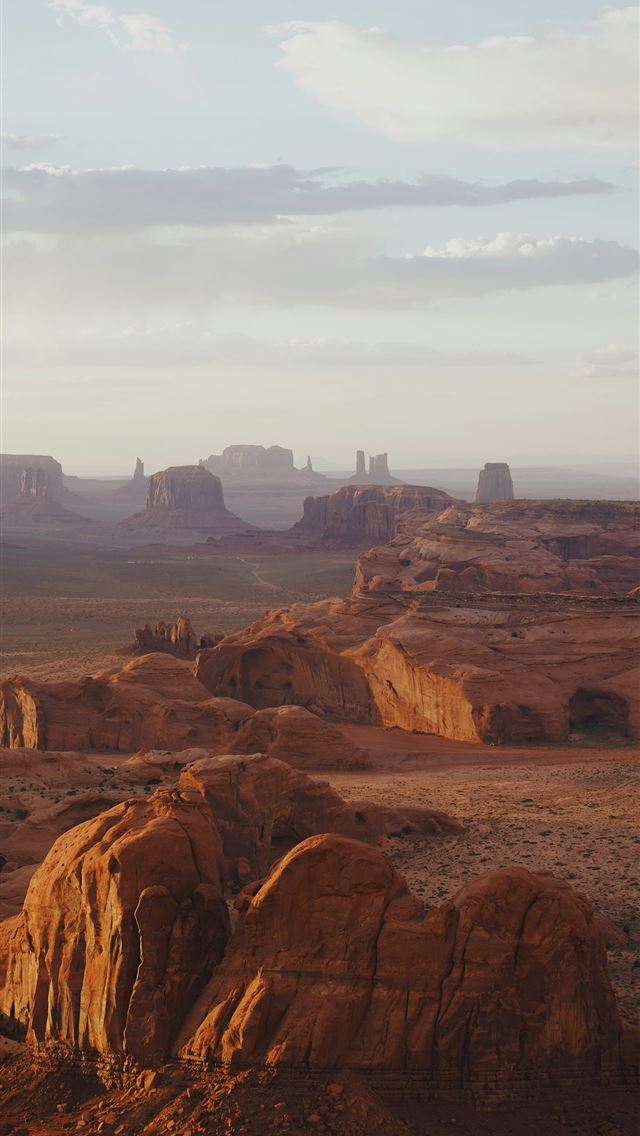 1290x2796 a desert landscape with rocks and mountains in the... -  iPhone Wallpaper