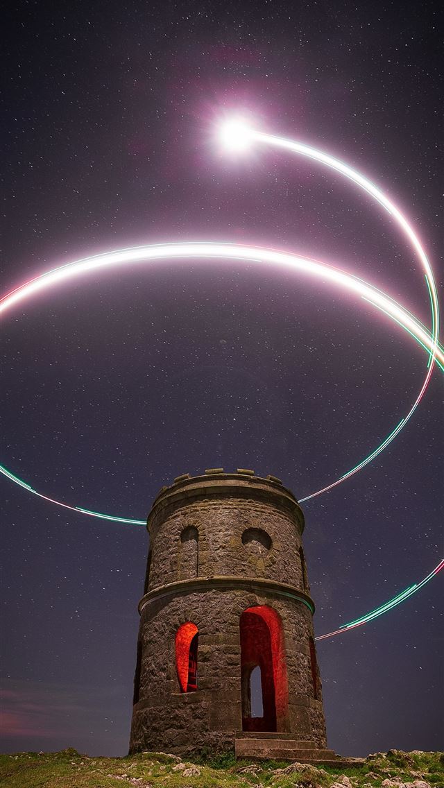 1290x2796 a tower with lights in the sky -  iPhone Wallpaper