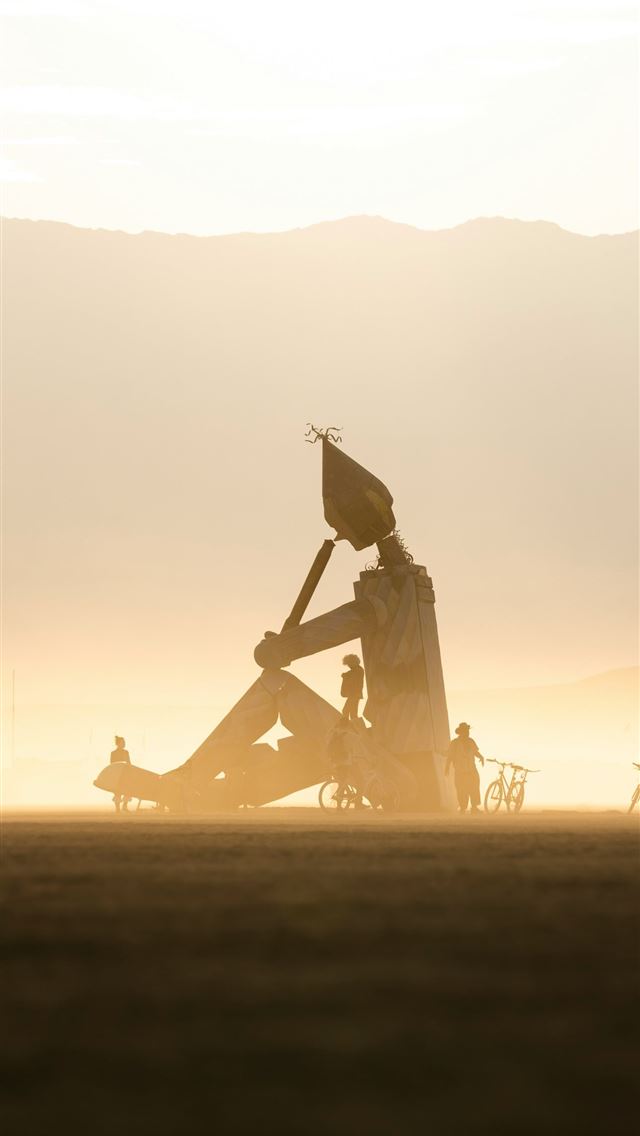 1290x2796 A couple of people sitting on top of a field -  iPhone Wallpaper