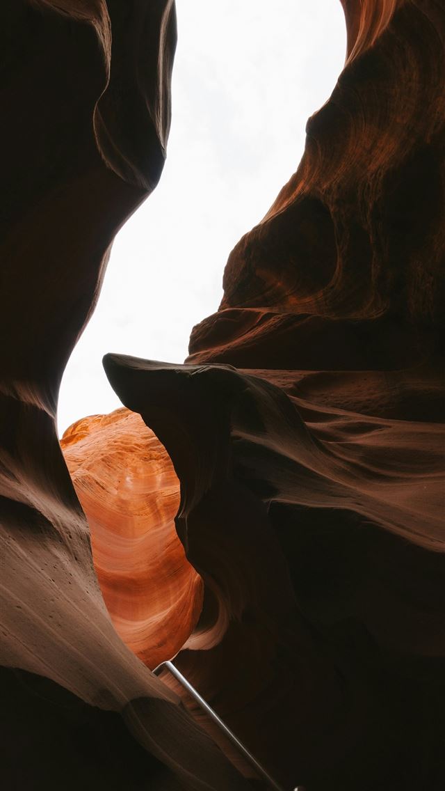 1290x2796 A narrow slot in the side of a rock formation -  iPhone Wallpaper
