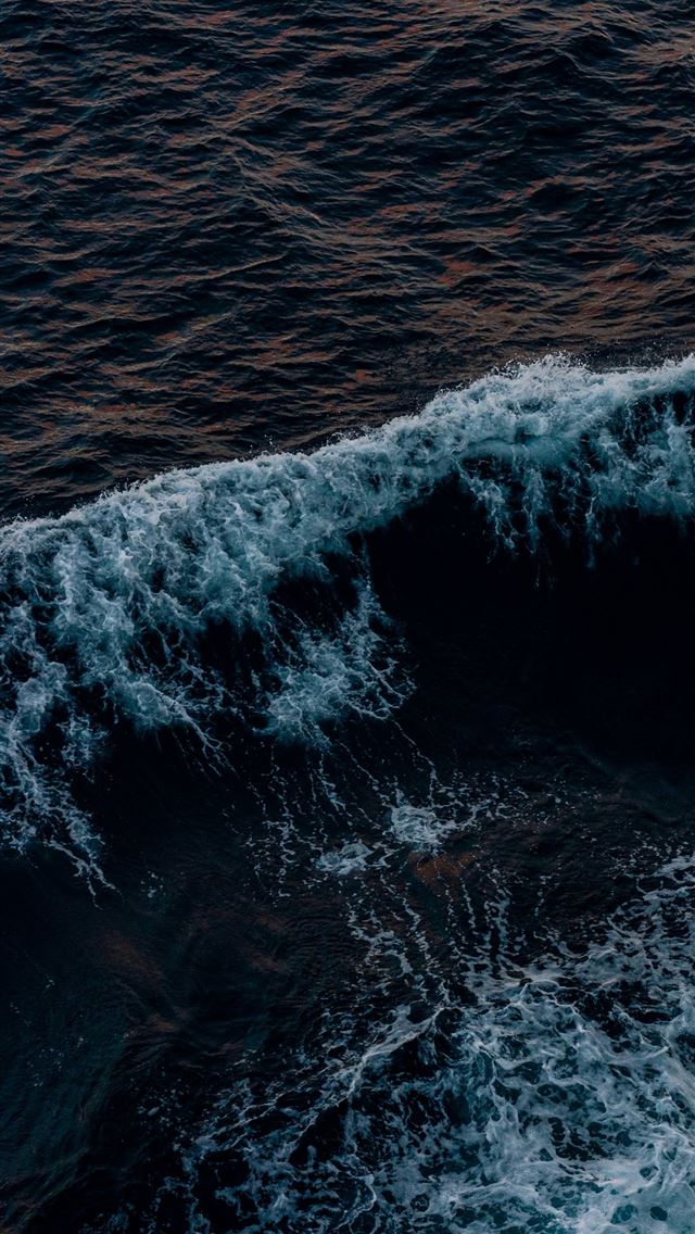 1290x2796 A person riding a surfboard on top of a wave -  iPhone Wallpaper