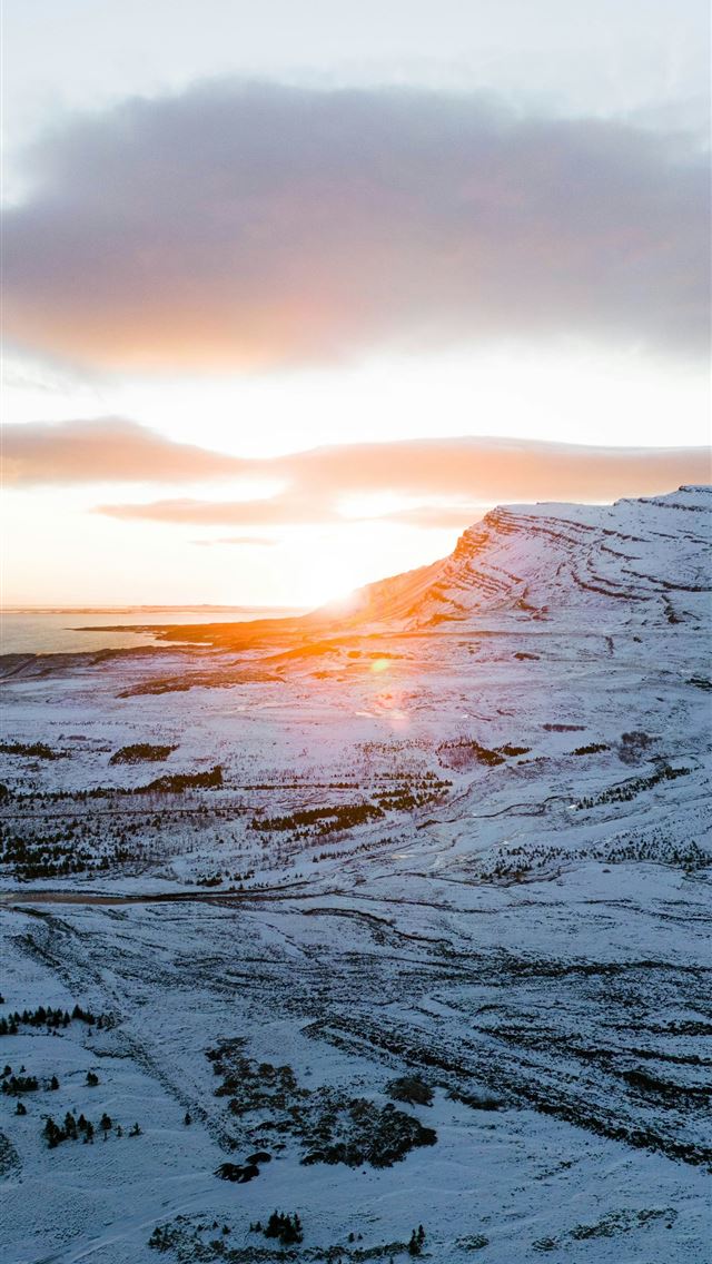 1290x2796 Sunset illuminates a snowy mountain landscape  -  iPhone Wallpaper