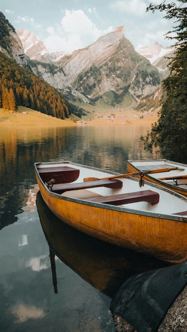 1290x2796 a group of boats on a lake -  iPhone Wallpaper